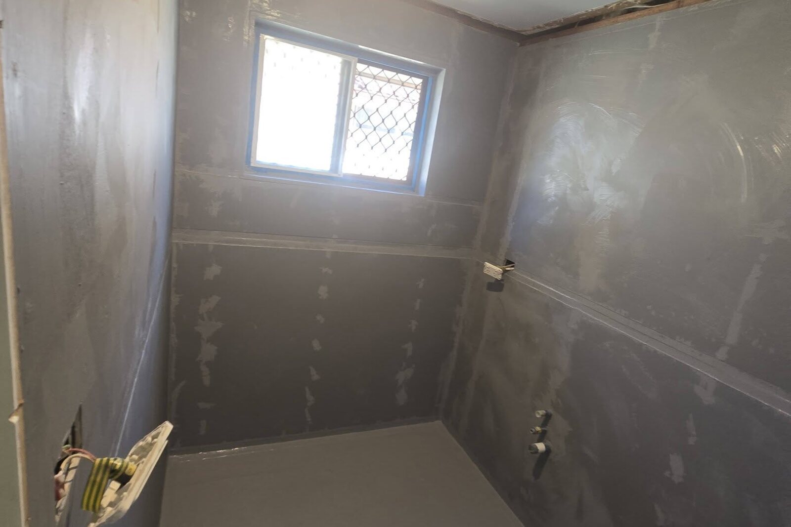 Waterproofing membrane applied to a shower recess floor and walls to Australian Standards by SLJ Express Tiling